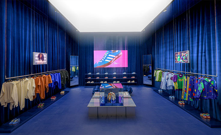 An adidas store with blue walls (Photo)