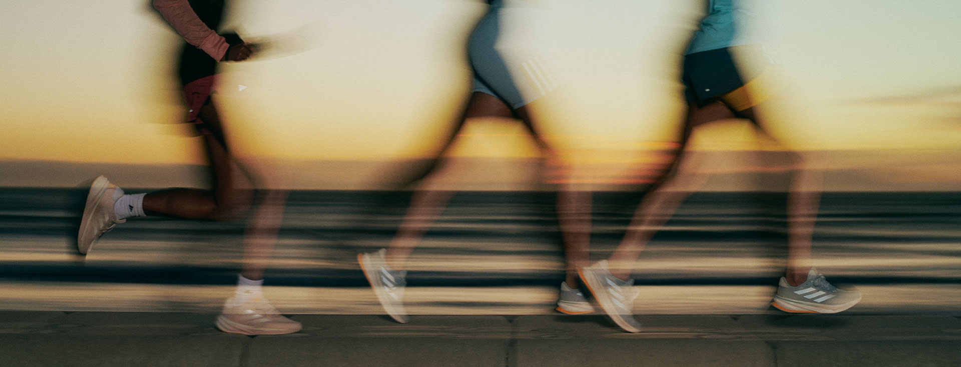 Three people running during the sunset (Photo)