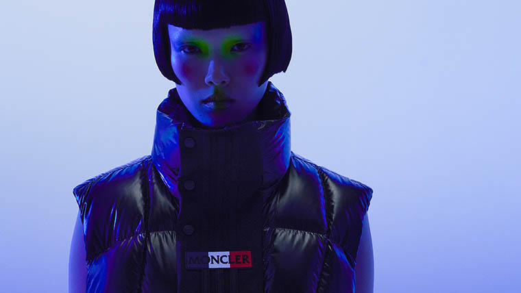 A woman with short hair and yellow eye shadow wears a black adidas x Moncler down jacket (Photo)
