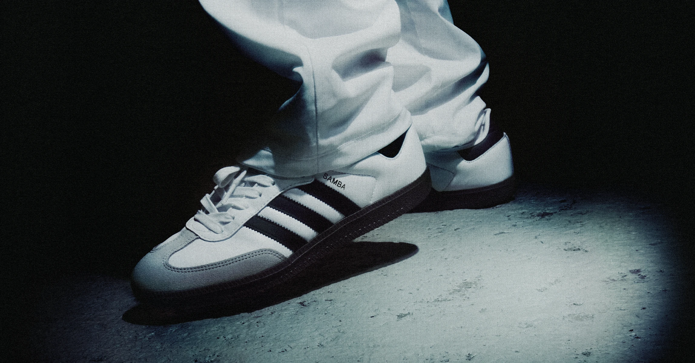 A close-up picture of a person's legs, wearing the adidas samba sneakers.