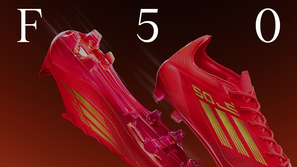 The image is an advertisement or a promotional graphic for a pair of red adidas sports cleats with the numbers "50" visible and presumably indicating their model number.