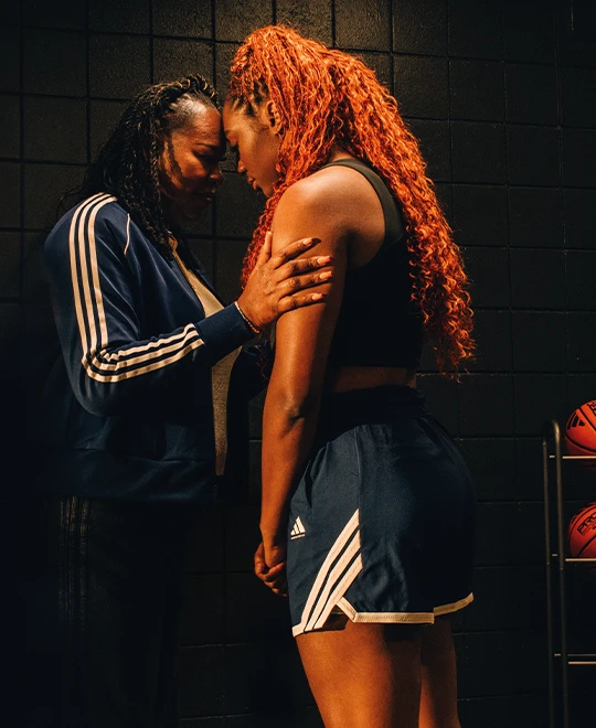  An emotional picture of a female athlete, connecting with assumingly her coach or mother before an important event. (Photo)