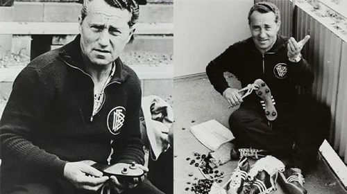 The image shows a person sitting on the floor. It appears to be an old photo, judging by its quality and style of clothing. The person is repairing shoe soles, possibly for football players.
