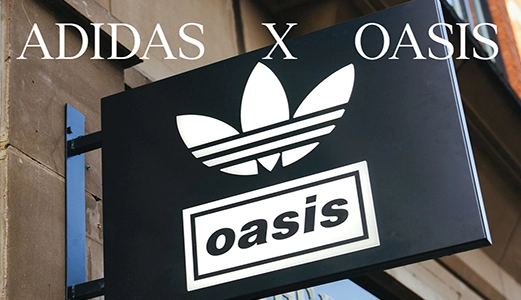 adidas x oasis Schild mit Trefoil-Logo an einer Hausfassade. (Foto)