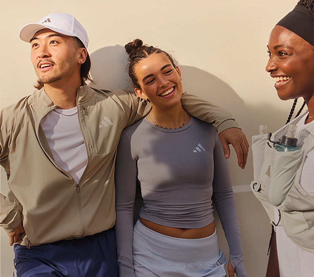 Group of young people talking while wearing adidas sportswear. (Photo)