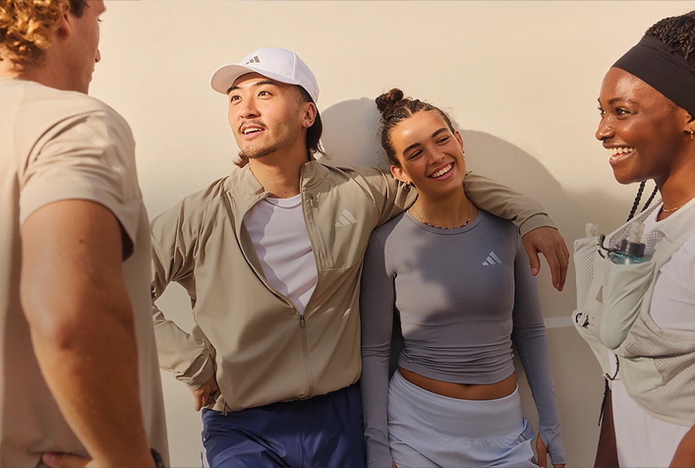 Group of young people talking while wearing adidas sportswear. (Photo)