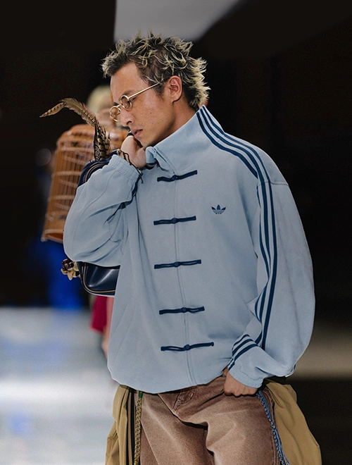 Male Model wearing an adidas jacket on a runway. (Photo)