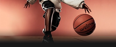 Basketball player dribbling a ball in an adidas outfit. (Photo)