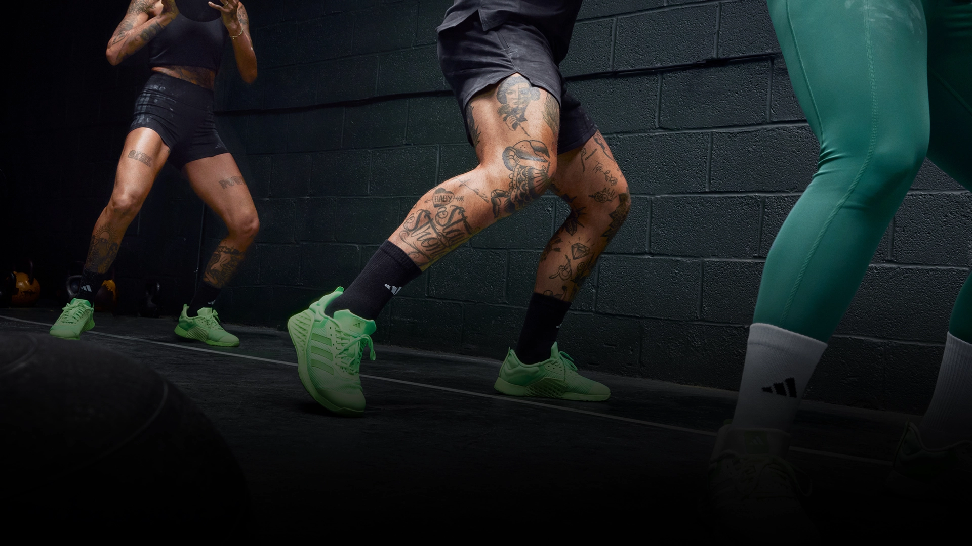 People doing functional training wearing neon adidas shoes. (Photo)