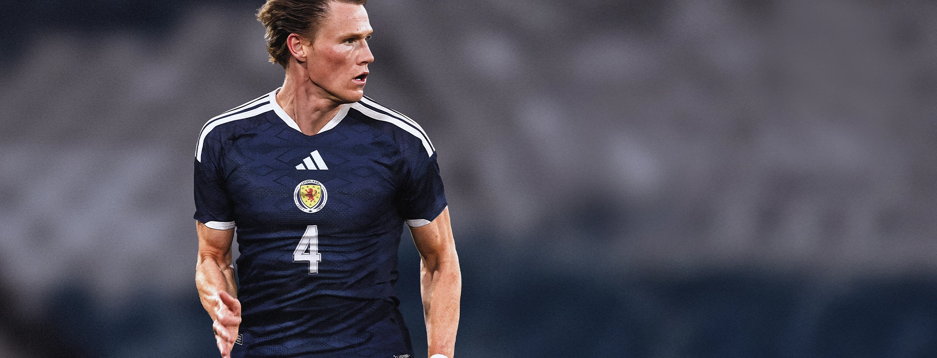 Scott McTominay in a dark blue Scotland adidas jersey during a match. (Photo)